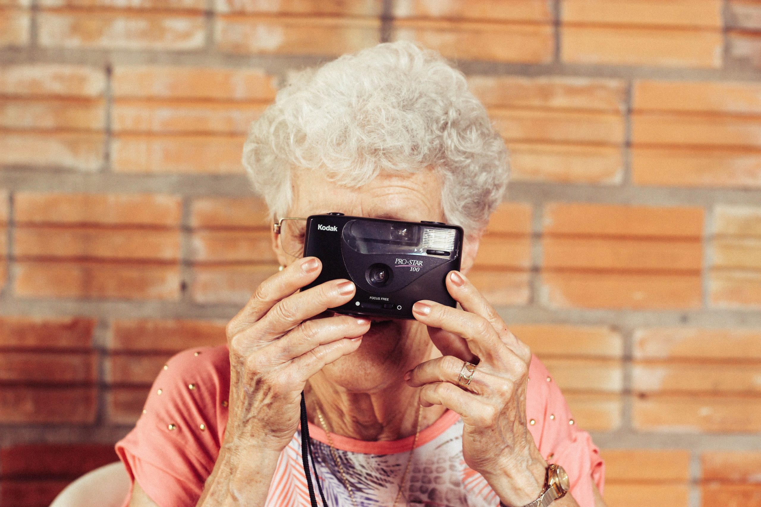 older woman holding camera